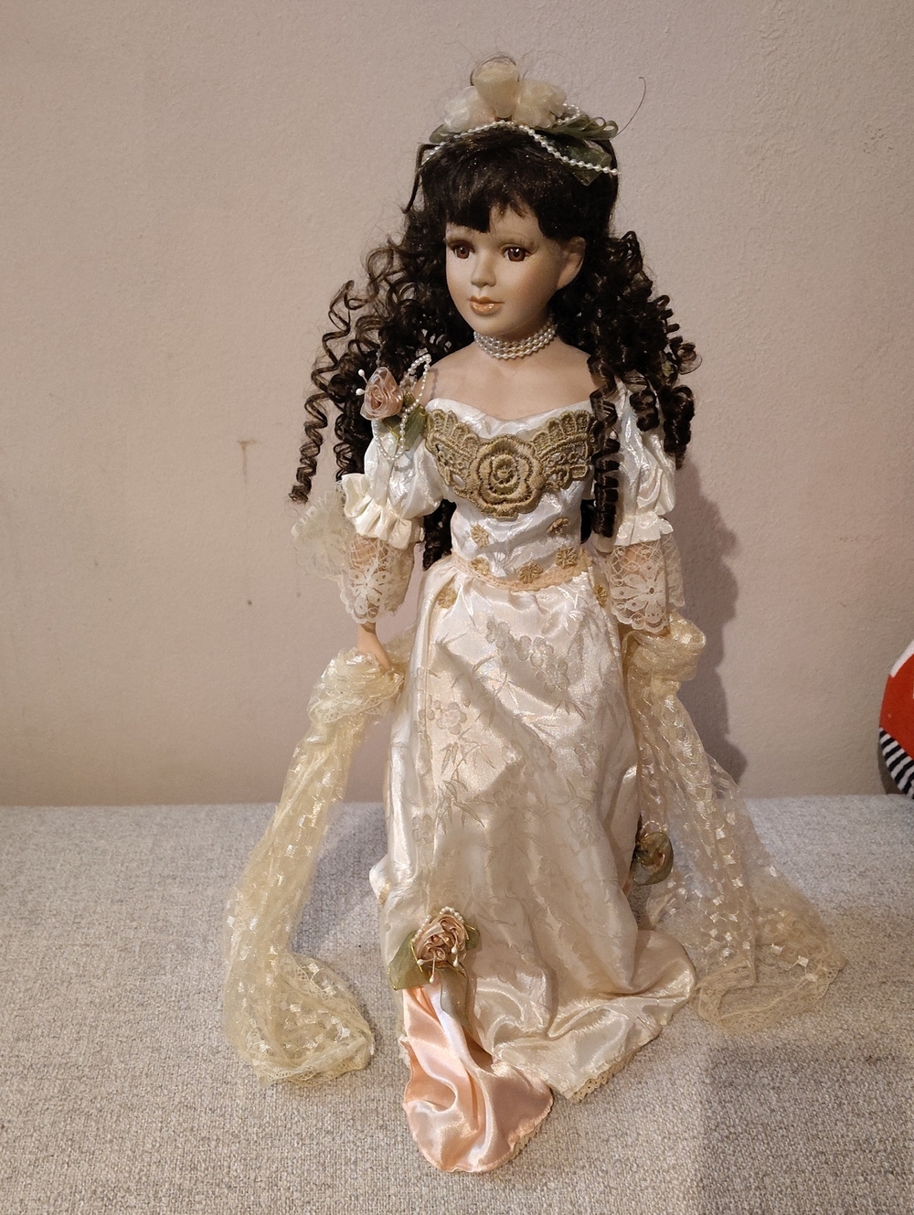 Porcelain-Style Fashion Doll in Cream and Gold Gown with Dark Curly Hair